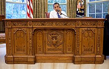 A man sitting behind a desk
