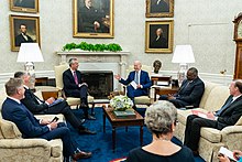 Photo of Biden, Stoltenberg, and staffers sitting in the Oval Office