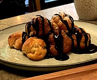 Classic Profiteroles serving, with chocolate sauce