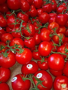Red tomatoes with PLU code in a supermarket