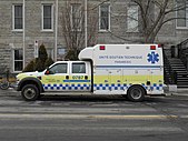 A paramedic truck parked in Montreal with Battenburg markings.