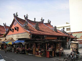 Roadside stalls selling prayer paraphernalia beside the Goddess of Mercy Temple.
