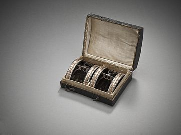 Man's shoe buckles with case. Paste stones with gilded-copper-alloy trim on silver and steel, France, c. 1785. LACMA M.2007.211.829a-b.