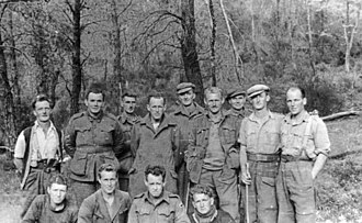 a group of males wearing a variety of uniform and civilian clothing items