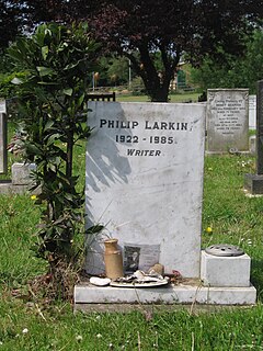 Headstone marking Larkin's grave at Cottingham Cemetery, Cottingham, East Riding of Yorkshire. The headstone is light-grey and has a ground level built-in vase for flowers on its right side. When seen in 2008 there was a small green bush growing just to its left. The headstone is inscribed with the words "Philip Larkin 1922–1985 Writer" on three lines with the dates on the middle line. It is situated in a cemetery with other headstones.