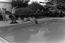 Susan Ford helping her father dive into the new swimming pool