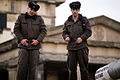 East German border guards stand atop the Berlin Wall