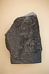 Stele of the Akkadian king Naram-Sin. The "-ra-am" and "-sin" parts of the name "Naram-Sin" appear in the broken top right corner of the inscription. Istanbul Archaeological Museum.