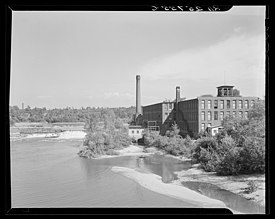 black and white photo of textile mill along river in Winooski, Vermont