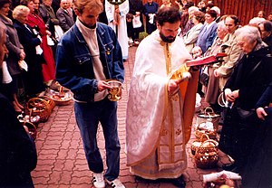 A priest blessing baskets with Easter eggs and other foods forbidden during Great Lent