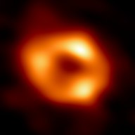 A dark spot surrounded by doughnut shaped orange-yellow ring