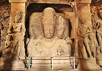 Inside a cave temple at Elephanta, Trimurti Shiva flanked by the dvarapalas, 5-6th century