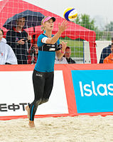A beach volleyball player in leggings