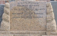 a colour photograph of a brown granite or marble headstone
