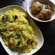 Saffron pulao served alongside eggs in gravy