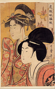 A colour print of a close-up of the head and upper torso of a finely dressed Japanese woman. Behind her is a bamboo screen on which is depicted a similar woman's head and upper torso.