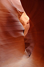Red sandstone interior of Lower Antelope Canyon, Arizona, worn smooth by erosion from flash flooding over thousands of years