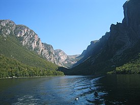 body of water with mountains in background