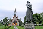 Statue of Longfellow's Evangeline (by Louis-Philippe Hébert) and memorial church.