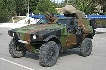 Front view of a VBL with a French-style camouflage. The older Greek flag is painted on its license plate.