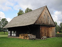 Board-on-board siding and half timber-framed barn in Olsztynek, north Poland