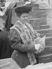 Frances Cleveland stands holding a trowel