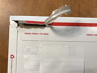 Closed mailer being opened by pulling tear tape