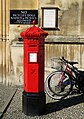 A Victorian hexagonal red post box, designed by the architect J. W. Penfold