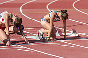 Athletes kneeling to prepare for a race