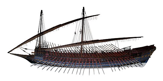 Model of a large galley with a blue hull, red decking and elaborate gold ornaments on its stern