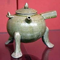 Ewer, lidded tripod with handles, used for heating certain alcoholic drinks. Stoneware with pale green (celadon) glaze. Six Dynasties, 500-580 CE. Victoria and Albert Museum, London