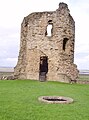 The castle well and a corner tower with some of its original ashlar cladding.