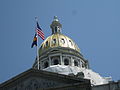 The state flag flying under the national flag at the Colorado State Capitol