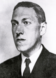 Head and shoulders of a man in a jacket and tie
