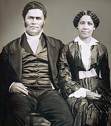 Black and white portrait of the couple sitting side by side