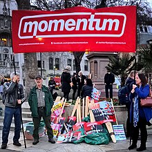 People holding up a Momentum banner at a rally