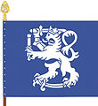 The colour of the Finnish Defence Forces International Centre features a Lion of Finland holding a herald's staff in addition to a sword. The shade of blue is the same as in the flag of the United Nations.