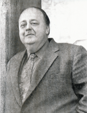 A black-and-white photograph of Roy Brocksmith