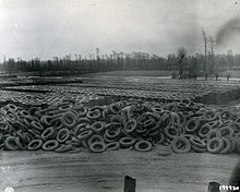 thousands of tires, some neatly stacked, others in a heap