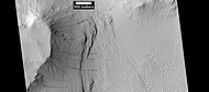 Layers under cap rock of a pedestal crater, as seen by HiRISE under HiWish program. Pedestal crater is within the much larger Tikhonravov Crater. Location is Arabia quadrangle.