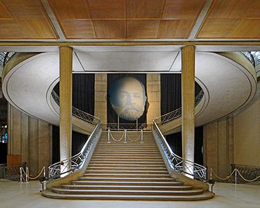 Stairway of the Economic, Social and Environmental Council, by Auguste Perret (with his portrait over the stairs) (1937)
