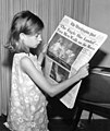 Image 9A girl reading a 21 July 1969 copy of The Washington Post reporting on the Apollo 11 Moon landing (from Newspaper)