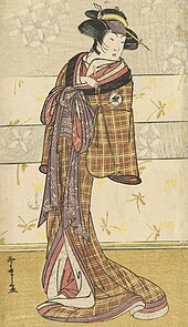 Japanese figure in a brown and yellow tartan-pattern kosode (early kimono)