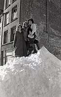 Women standing atop a snowdrift in Boston