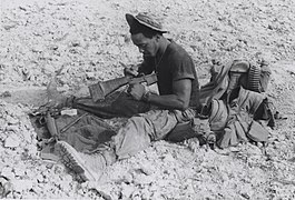 A Marine cleans his M16 rifle