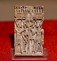 Carved ivory panel showing young Egyptian pharaohs flanking a lotus stem and flowers. From Nimrud, Iraq. Iraq Museum, Baghdad.