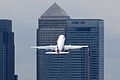 Airplane leaving London City Airport on the flight path near One Canada Square