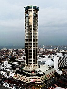 Komtar Tower, with the podium visible below and surrounded by low-rise buildings.