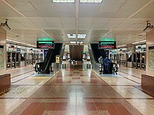 The lower platform level, with escalators leading up to the other levels of the station