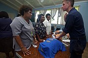 Aboard the Military Sealift Command (MSC) hospital ship, USNS Mercy, YN3 Dan S. Konzek demonstrates how to properly locate the carotid pulse to nurses from the Modilion General Hospital in Madang, Papua, New Guinea. USNS Mercy had just completed tsunami and earthquake relief operations in Indonesia (2005).